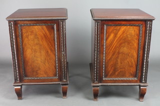 A pair of 19th Century mahogany pedestal cabinets with shelved interiors enclosed by panelled doors, raised on scroll feet 31"h x 20 1/2"w x 31"d 