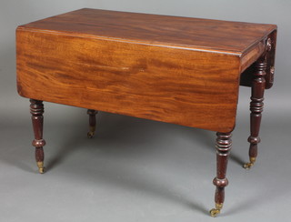 A William IV mahogany Pembroke table fitted a frieze drawer, raised on turned supports ending in brass caps and casters, 29"h x 41"w x 22 1/2"l when closed by 47" when open 