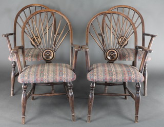 A set of 4 Art Nouveau mahogany open arm stick and wheel back chairs with turned supports and H framed stretchers 