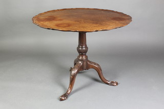 An Edwardian Chippendale style circular snap top tea table with bracketed border, raised on a turned and fluted column with triform base and egg and claw feet 27"h x 33" diam. 