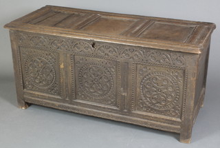 An 18th Century carved oak coffer of panelled construction, the hinged lid revealing a candle box and retaining 2 original hinges 25"h x 52"w x 22"d 
