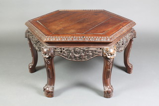 A Chinese hexagonal carved and pierced Padouk occasional table, raised on 6 claw and ball supports with dragon mask decoration 18"h x 34"w x 29 1/2"d 