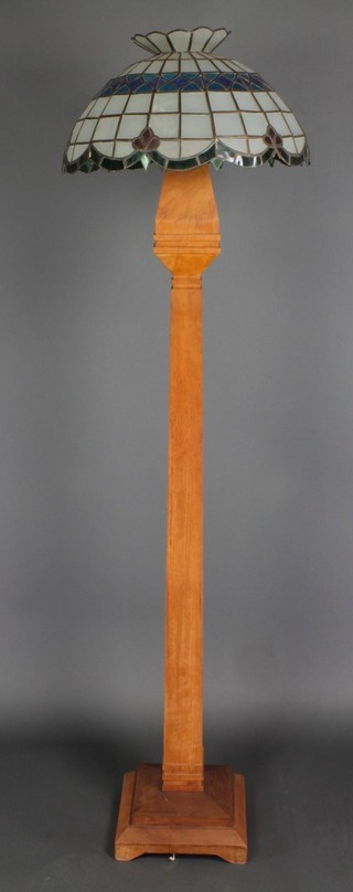 An Art Deco square tapered hardwood standard lamp, raised on a stepped base and with a lead glazed shade 62"h 