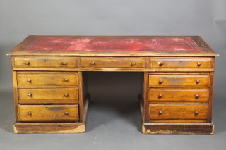 A Victorian mahogany kneehole desk with inset red leather writing surface, fitted 3 long and 6 short drawers with tore handles 30"h x 72"d x 37"w 