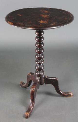 A 19th Century circular mahogany wine table raised on turned column and tripod base 25"h x 17" diam. 