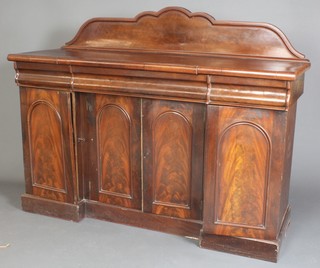 A Victorian mahogany chiffonier sideboard with raised shaped back above 1 long and 2 short secret drawers above a triple cupboard enclosed by arched panelled doors 46"h x 59"w x 21"d 