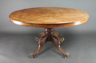 A Victorian oval figured walnut Loo table, the top with quarter veneers, raised on a carved column and tripod base 27 1/2"h x 53"w x 40"d