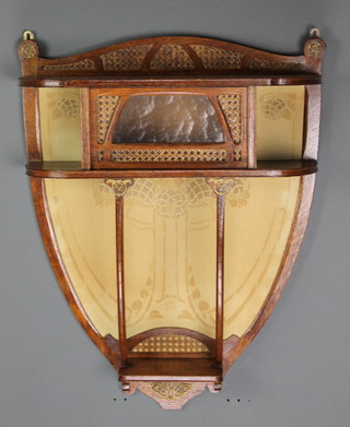 An Art Nouveau oak hanging shield shaped bracket/cupboard enclosed by a panelled door 24"h x 21"w x 9"d 