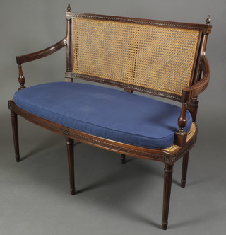 An Edwardian style carved mahogany 2 seat settee, the seat and back with woven cane panels, raised on 6 turned and fluted supports 40"h x 48"w x 22"d 