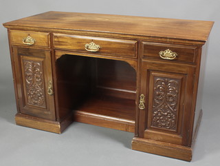 A Victorian walnut dressing table fitted 1 long drawer flanked by a recess above 2 short drawers and double cupboards enclosed by panelled doors, 29"h x 51"w x 24"d 