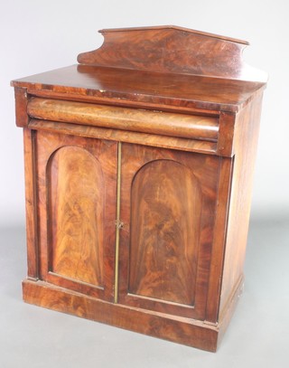 A Victorian mahogany chiffonier with shaped back, fitted a secret drawer enclosed by arch panelled doors, raised on a platform base 42"h x 32"w x 19"d 
