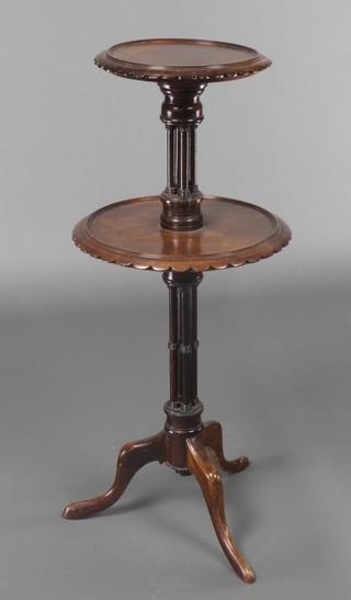 A Chippendale style mahogany circular 2 tier display stand, raised on 4 turned columns with tripod base 29"h, the upper section 9" diam., the lower section 12" diam. 