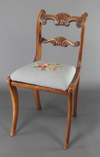 A Georgian mahogany carved bar back chair with mid rail and Berlin wool work upholstered drop in seat, raised on sabre supports 