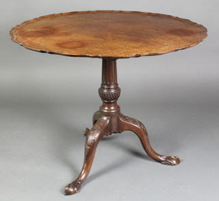 An Edwardian Chippendale style circular snap top tea table with bracketed border, raised on a turned and fluted column with triform base and egg and claw feet 27"h x 33" diam. 