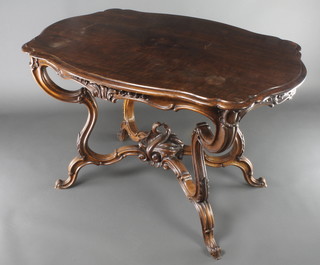 A Victorian carved walnut centre table of serpentine outline, raised on 4 cabriole supports united by a carved X framed stretcher 28"h x 45"w x 30"d 