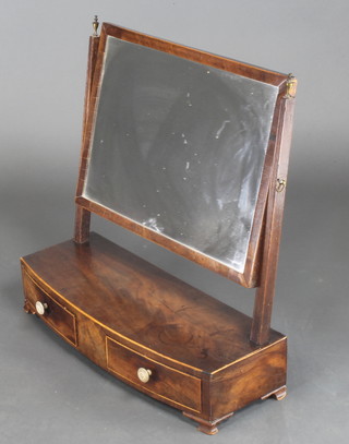 A Georgian mahogany rectangular plate dressing table mirror contained in a mahogany swing frame, the bow front base fitted 2 drawers with ivory handles, raised on ogee bracket feet 18"h x 21"w x 8"d 