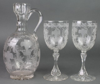 A pair of cut crystal wine glasses decorated with fleur de lis amongst scrolling flowers and an ensuite ewer