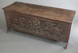 A 17th/18th Century oak coffer of panel construction, the front panel carved scenes of fighting knights 25"h x 59"w x 20"d 

