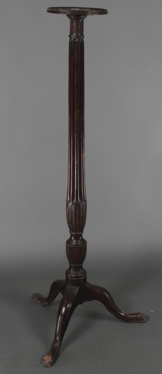 A 19th Century mahogany torchere raised on turned and reeded column with tripod base 55"h x 9" diam. 