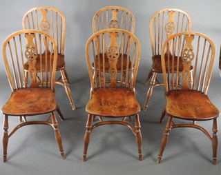 A set of 6 18th Century style elm stick back dining chairs with screw in stretchers, raised on turned supports
