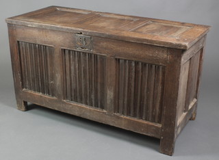 An 18th Century oak coffer of panelled construction, the front with linenfold decoration, the interior fitted a candle box 26"h x 41"w x 20"d 