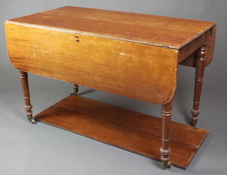 A 19th Century rectangular mahogany drop flap extending dining table, raised on turned supports, brass caps and castors 28"h x 44 1/2" x 24" when closed x 48" when open