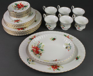 A Royal Albert Poinsettia design tea and dinner service comprising 6 tea cups, 6 saucers, 6 side plates, 6 dinner plates, an oval dish and bowl