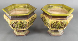 A pair of Doulton style hexagonal jardineires decorated with panels of cherubs 16" 
