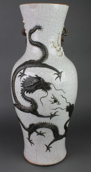 A Chinese cream crackle glazed oviform vase decorated with a dragon chasing the flaming pearl with serpent handles and seal mark to base 24" 