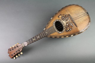 An 8 stringed mandolin, labelled Stridente Fabrica di Mandolini via Antonio 22 Napoli 
