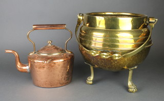 A brass coal bin in the form of a cauldron with swing handle raised on 3 paw feet, together with an oval copper kettle