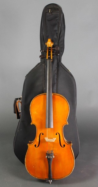 A cello with 2 piece back, bearing label Breton Brevette, 24", together with an unmarked bow, contained in a soft plywood carrying case 