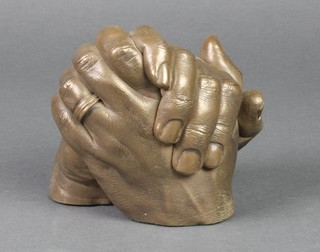 A bronzed sculpture of a pair of hands clenched in prayer 10" 