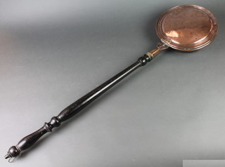 An 18th/19th Century copper warming pan with turned ebony handle