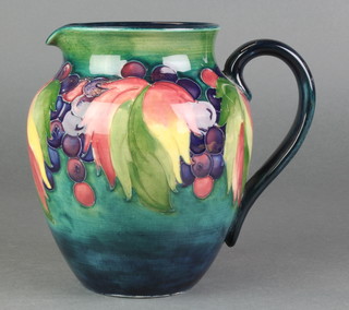 A William Moorcroft pottery baluster jug decorated with grapes, printed signatures and Potter to HM The Queen 6 1/2" 