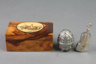 A Victorian walnut effect trinket box 1 1/2" x 3" x 2" containing a white metal vesta case in the form of a violin and a white metal pin cushion in the form of a boiled egg