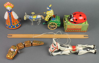 A metal figure of Muffin The Mule, a tin plate figure of a clown trotting cart 8", a tin plate metal figure of a standing Russian girl marked 80, a Russian clockwork figure of a ladybird, a tin plate clockwork figure of a crocodile 