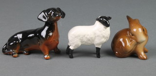 A Beswick figure of a seated Dachshund 4", a ditto of a sheep 2 1/4" and a figure of a seated rabbit 