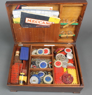 A collection of various green and red Meccano, contained in a box with hinged lid 