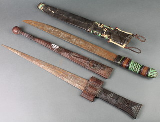 A reproduction Eastern double bladed dagger 17" with leather scabbard and 1 other with a single blade 17" 