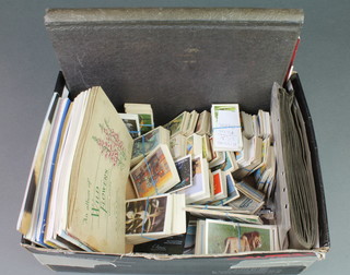 A collection of various cigarette and tea cards