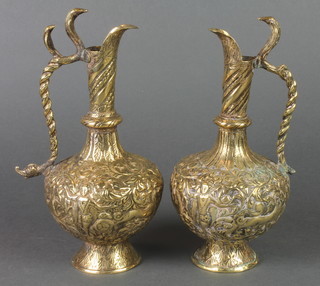 A pair of Benares brass embossed ewers with cobra handles 9" 