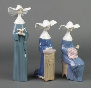 Three Lladro figures of nuns, 1 kneeling 5502 9", 1 sewing 5501 8" and 1 reading 5500 10 1/2" 