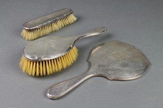 A silver backed hair brush and hand mirror, Birmingham 1924 and a silver backed clothes brush