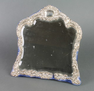 An Edwardian repousse silver easel mirror with bevelled plate 13 1/2" 