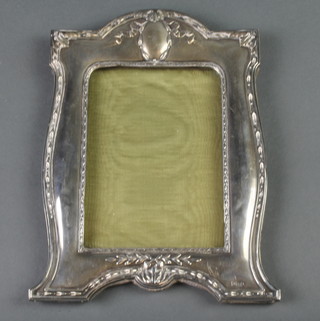 An Edwardian silver photograph frame with vacant cartouche, London 1906 8 1/2" x 6" 