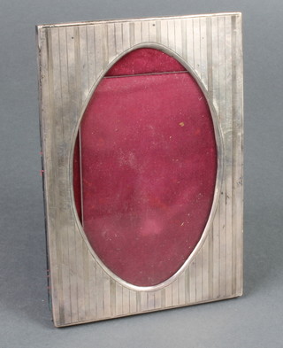 A rectangular silver engine turned photograph frame with oval opening, Birmingham 1912 7" x 5" 
