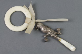 A silver and mother of pearl teether rattle in the form of a bird