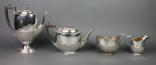 A silver 4 piece tea and coffee service of demi-fluted form, Birmingham 1912, coffee pot Sheffield 1914, gross 1682 grams