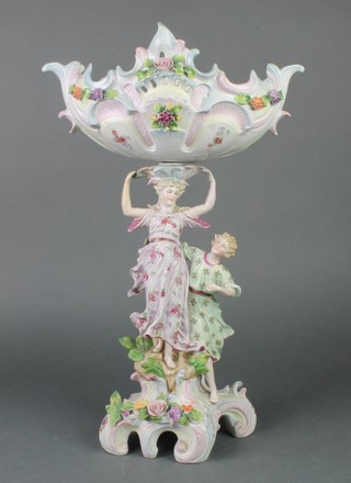 A German centrepiece with 2 figures supporting a floral encrusted basket on a Rococo base 17" 